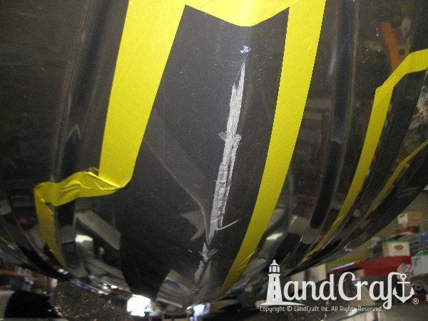 Grounding damage on hull of Nauticstar center console fiberglass boat