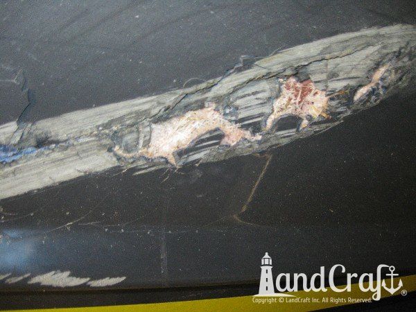 Grounding damage on hull of Nauticstar center console fiberglass boat
