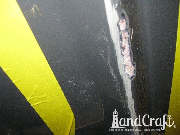 Grounding damage on hull of Nauticstar center console fiberglass boat