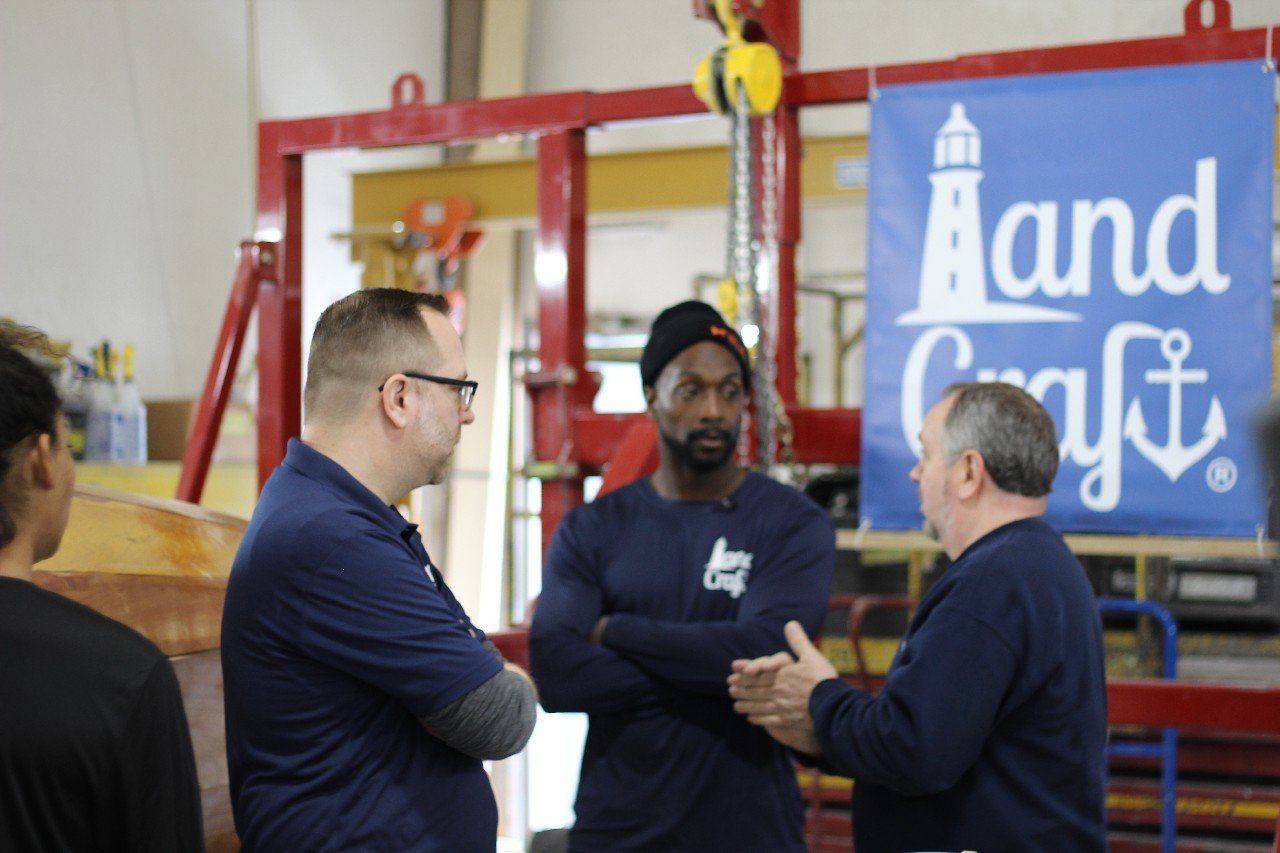 Keith is discussing the Row4Kids boat build with Charles and Jake