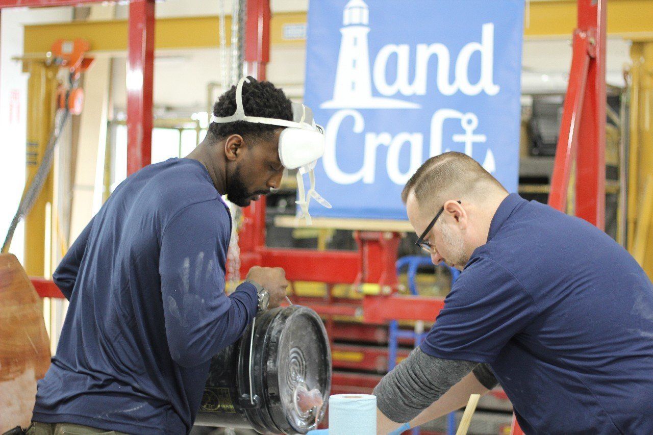 Charles and Jake mix materials for the Row4Kids boat build project