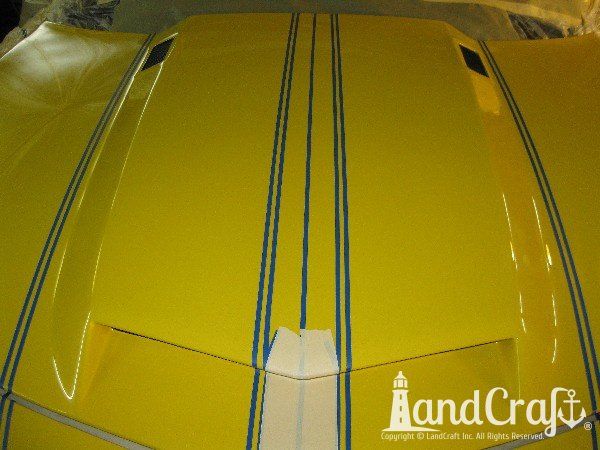 Fiberglass Chevy Camaro hood in rally stripe paint process