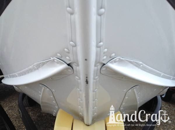 Aluminum Lund boat with damage along bow stem