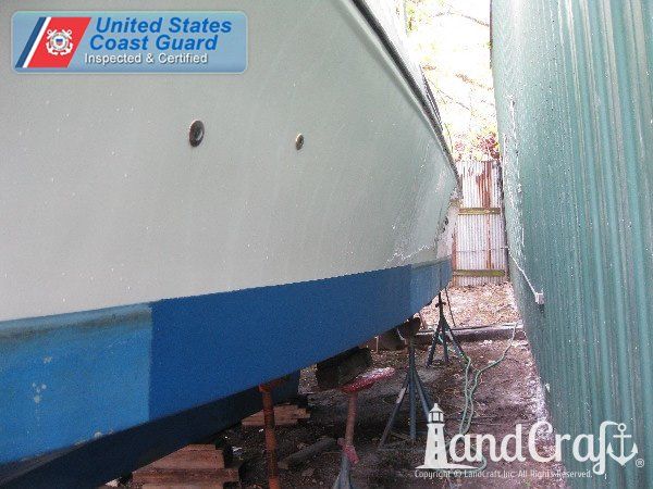 Commercial vessel with repairs completed and hull side refinished