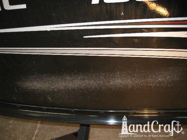 Picture of scratches through paint and decals on an aluminum boat