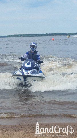 Yamaha waverunner with custom graphics in the water with racer riding