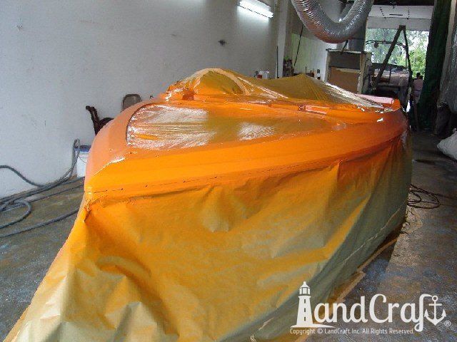 Malibu Echelon boat in orange exterior refinishing stage