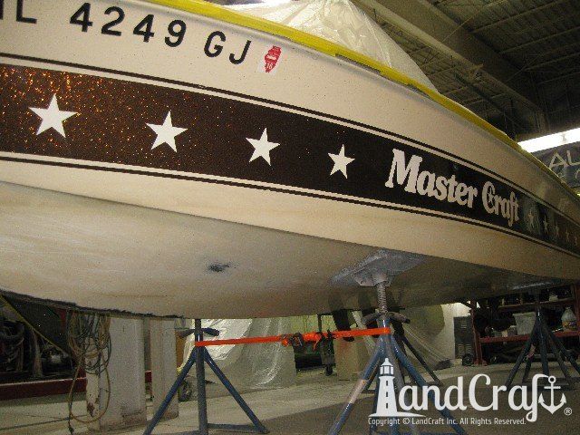 Mastercraft Stars & Stripes boat on a lift and ready for exterior repairs and gelcoat refurbishing