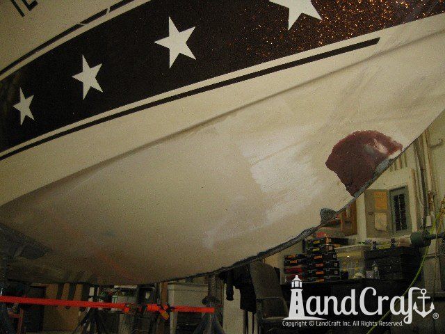 Mastercraft Stars & Stripes boat on a lift and ready for exterior repairs and gelcoat refurbishing
