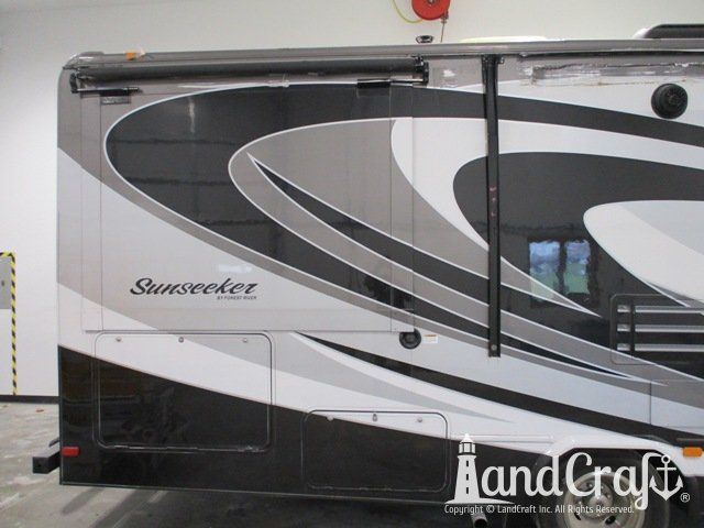 Forest River RV with side damage and tear punctured through due to an accident