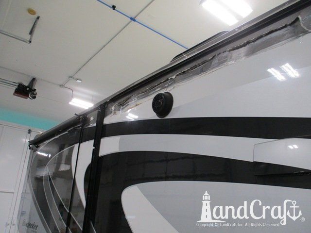 Forest River RV with side damage and tear punctured through due to an accident