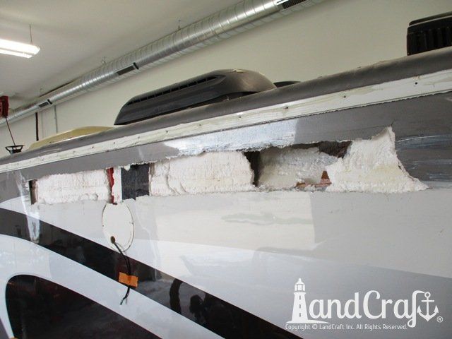 Forest River RV with side damage and tear punctured through due to an accident