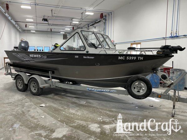 Picture of the repaired and refinished aluminum Hewescraft boat