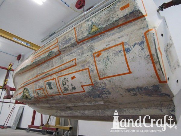 Grounding damage with holes on bottom hull of a fiberglass Boston Whaler boat