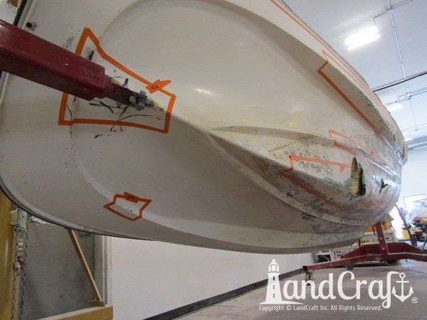 Grounding damage with holes on bottom hull of a fiberglass Boston Whaler boat