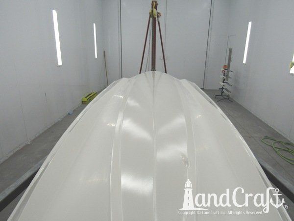 Boston Whaler in the LandCraft paint booth for gelcoat work on the bottom hull