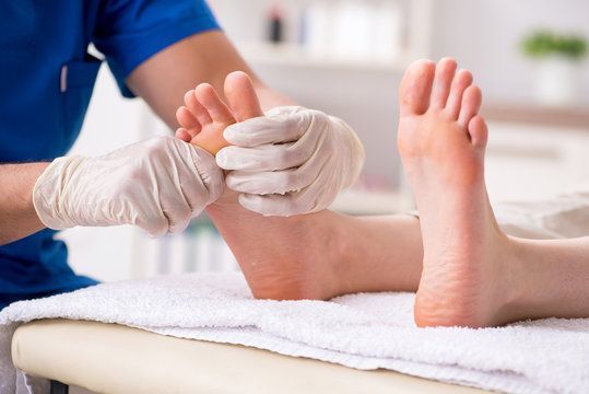 A person is getting foot care from a podiatrist.