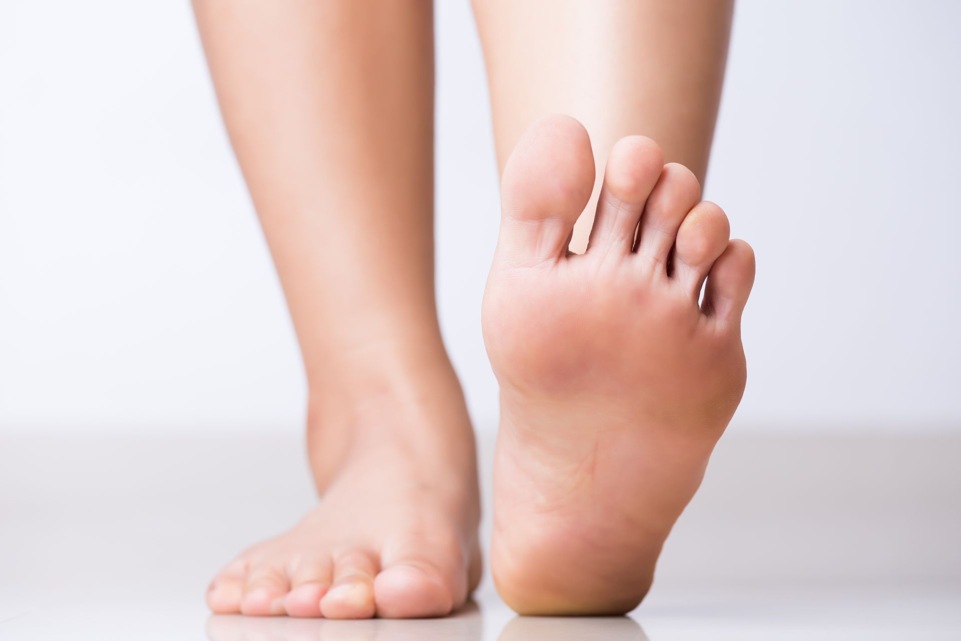 Closeup of female foot discomfort representing trusted foot care services for wellness.