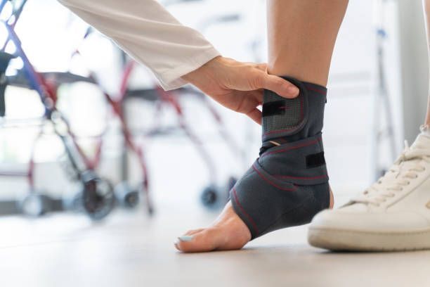Close-up of a woman's foot with a sports ankle brace.
