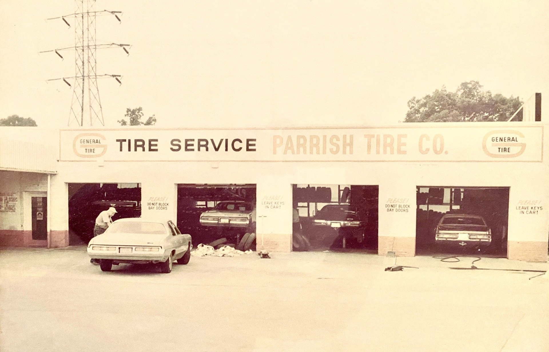 A black and white photo of a tire service parrish tire co.