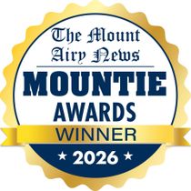 Gold seal reading โThe Mount Airy News Mountie Awards Winner 2026โ in blue and white.