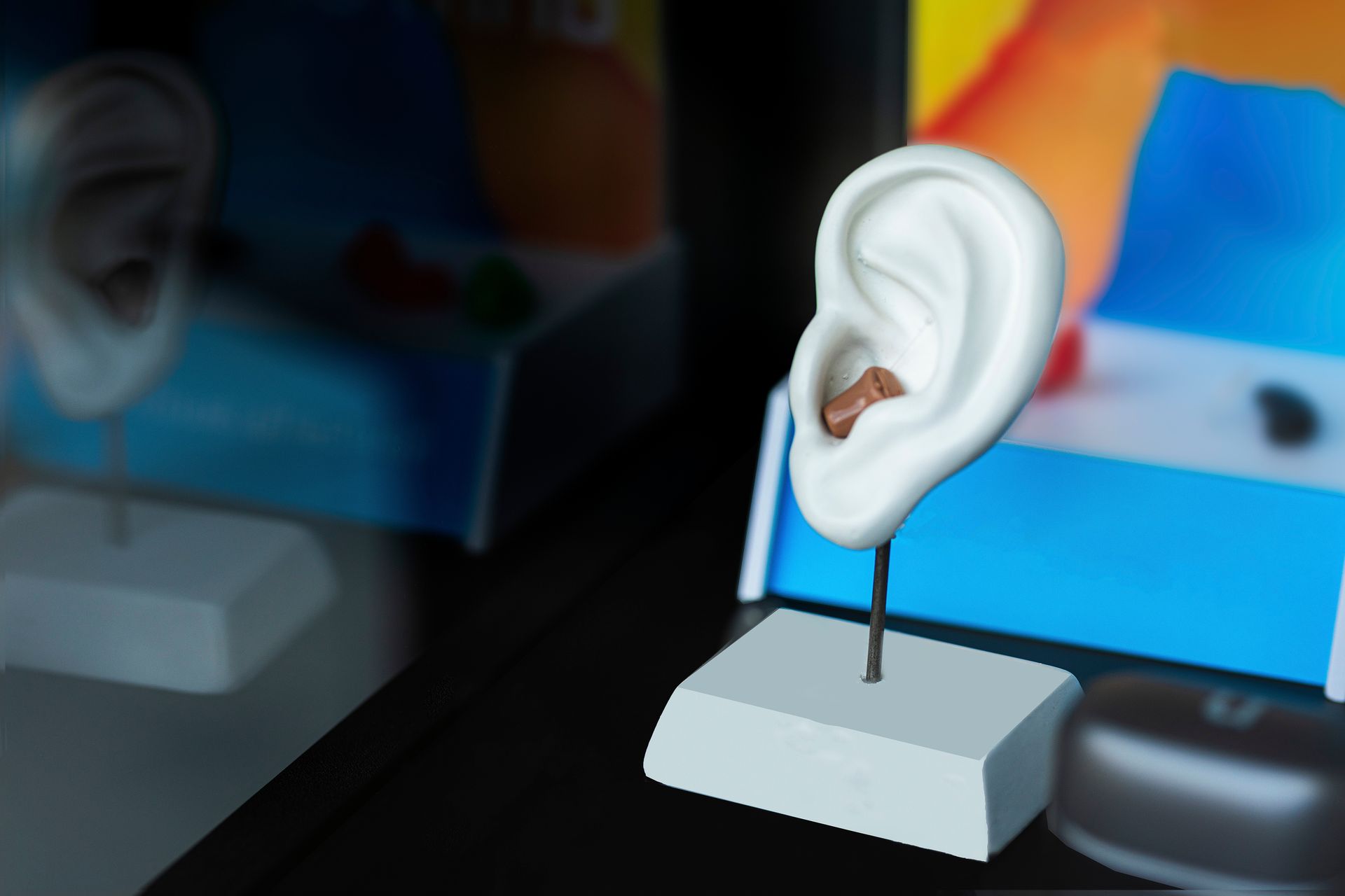 A close-up view of a miniature hearing aid for hearing loss.