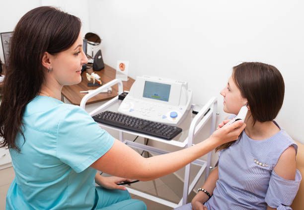 Picture of a medical care specialist examining a patient at a hearing aid clinic in Hampstead, NC