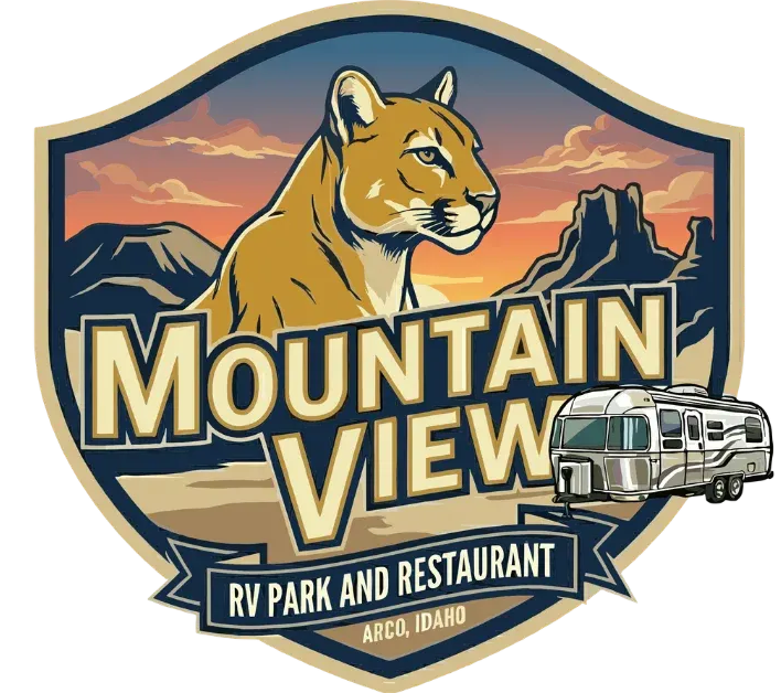 Mountain View RV Park and Restaurant logo featuring a cougar, mountains, RV, and sunset in Arco, Idaho.