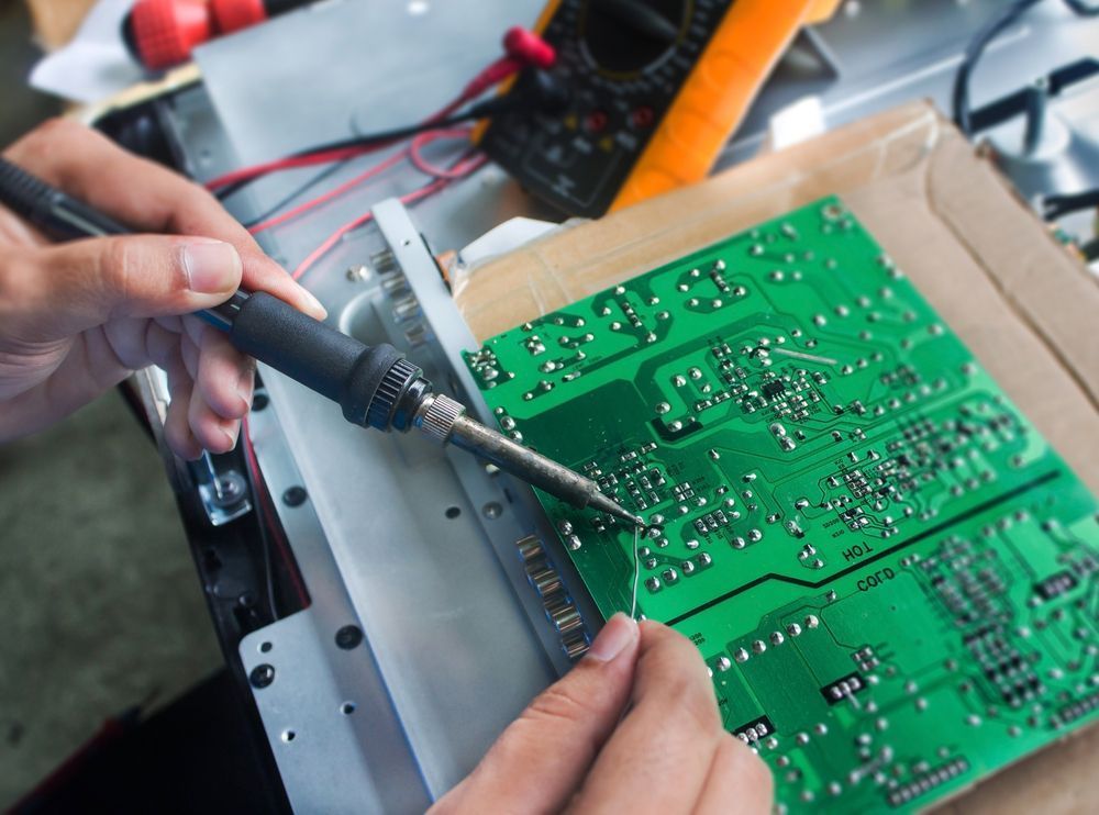 A Person is Holding a Motherboard in Their Hands — Garrow's TV & Antenna Services in Caloundra West, QLD