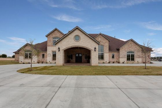 House with a large concrete driveway.