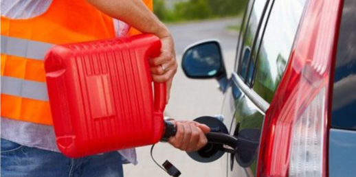 Picture of gas being poured into a vehicle with a jerry can and spout