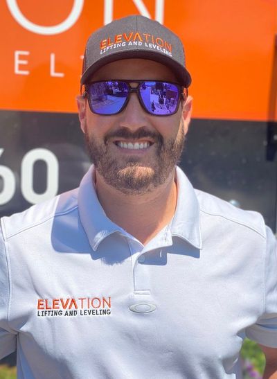 A man wearing sunglasses and a hat that says elevation