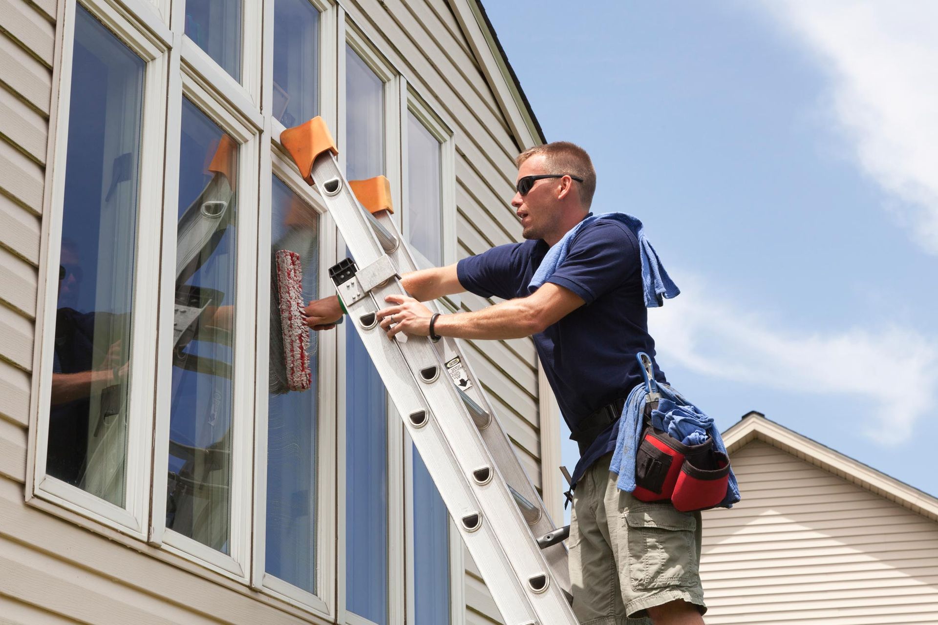 Professional Window Cleaning Crew at Work on a Two-Story Home