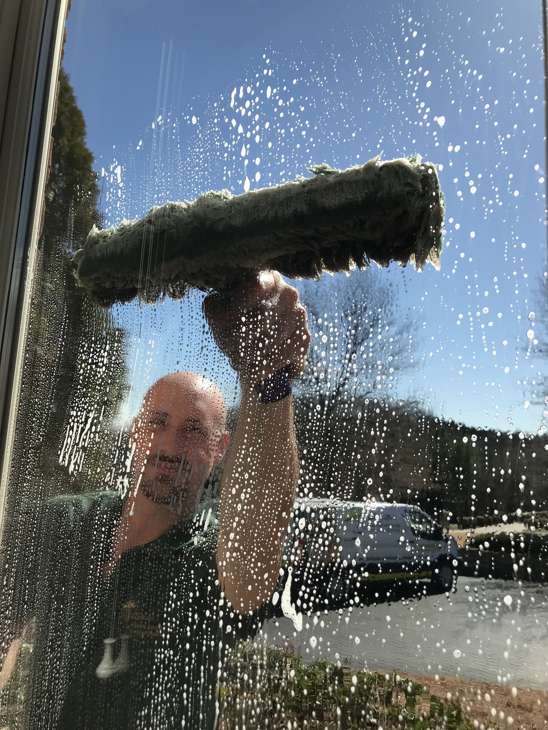Man Cleaning Window | Nashville, TN | Alpine Window Cleaning & Pressure Washing