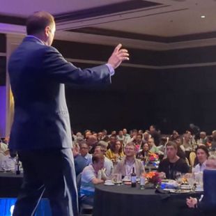 Magician David Martinez on stage at a large corporate event