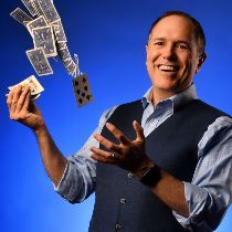 A photo of San Francisco magician David Martinez shooting cards up into the air.