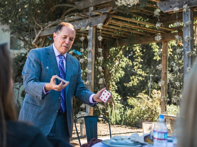 David Martinez holds a deck of cards in preparation for performing a close-up trick at a house party