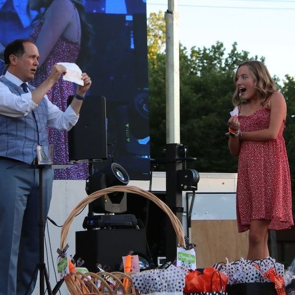 San Francisco Bay Area corporate magician David Martinez performs on stage to a shocked audience helper at a large event