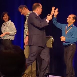 Guests on stage give magician David Martinez a high-five after a magic trick