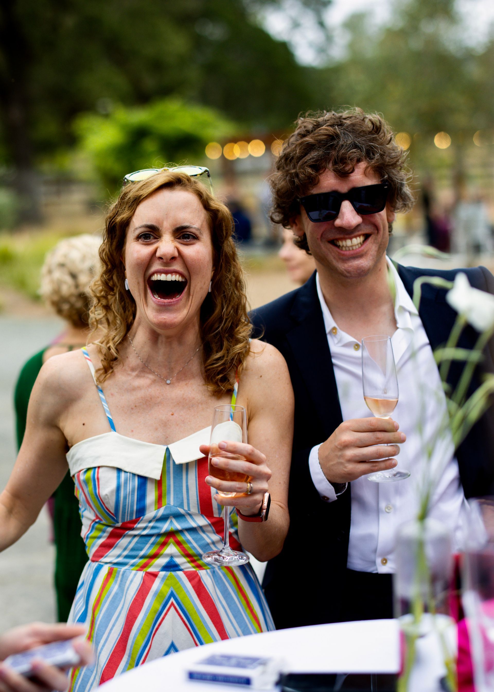 Two guests laugh at a magic trick by Bay Area magician David Martinez at a corporate event