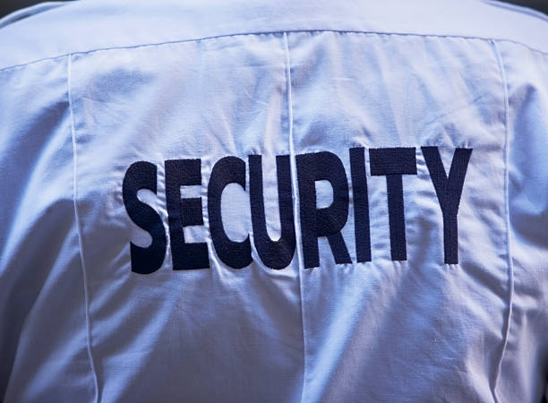 Back of a security guard's uniform with the word 