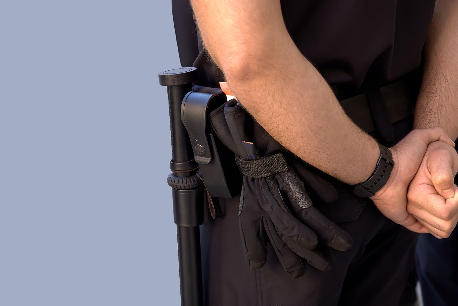 Security officer uniform with duty belt, baton, and gloves shown from the side.