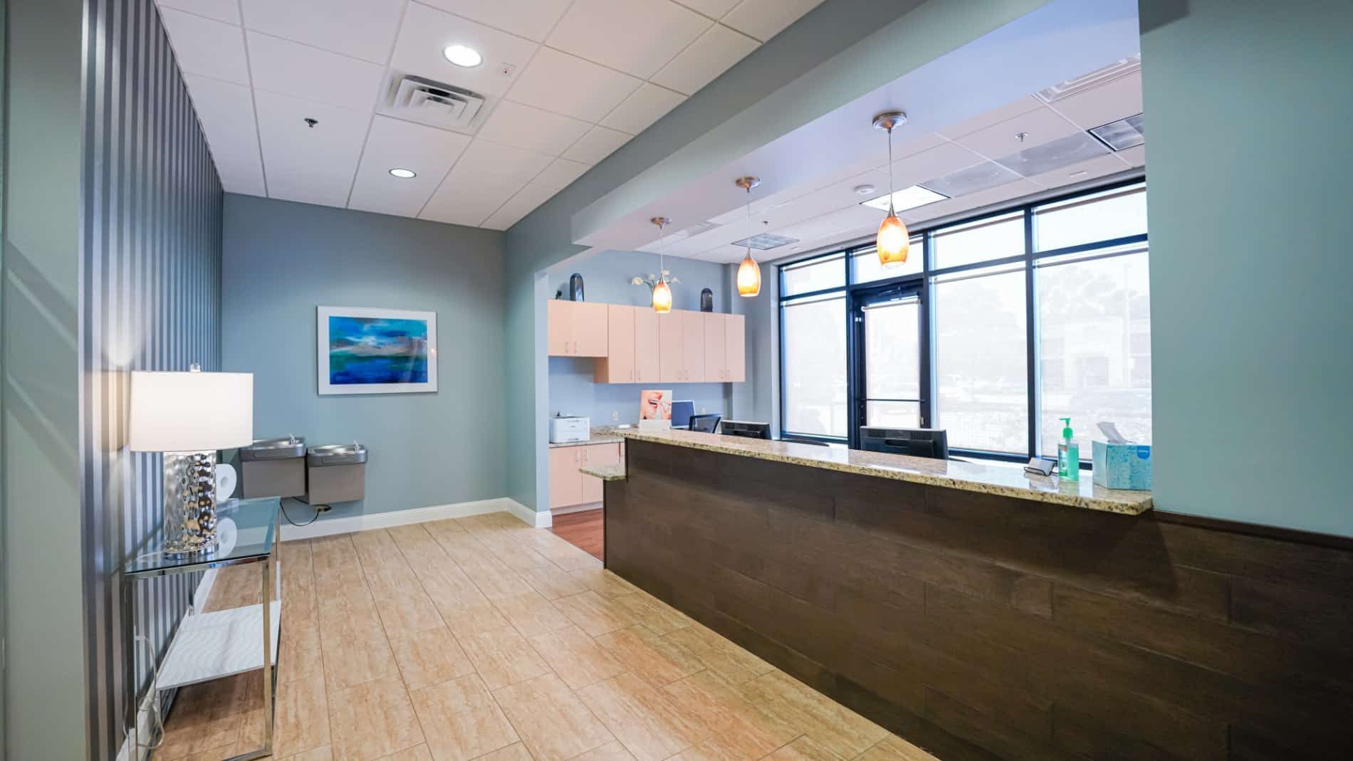 A large room with a wooden floor and a counter in the middle of it.
