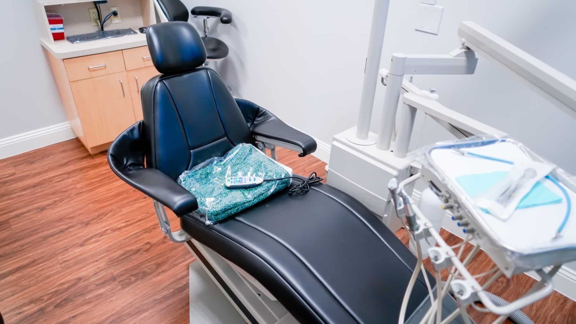 An empty dental chair in a dental office.