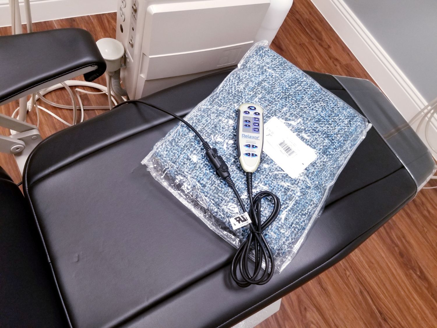 A remote control is sitting on top of a dental chair
