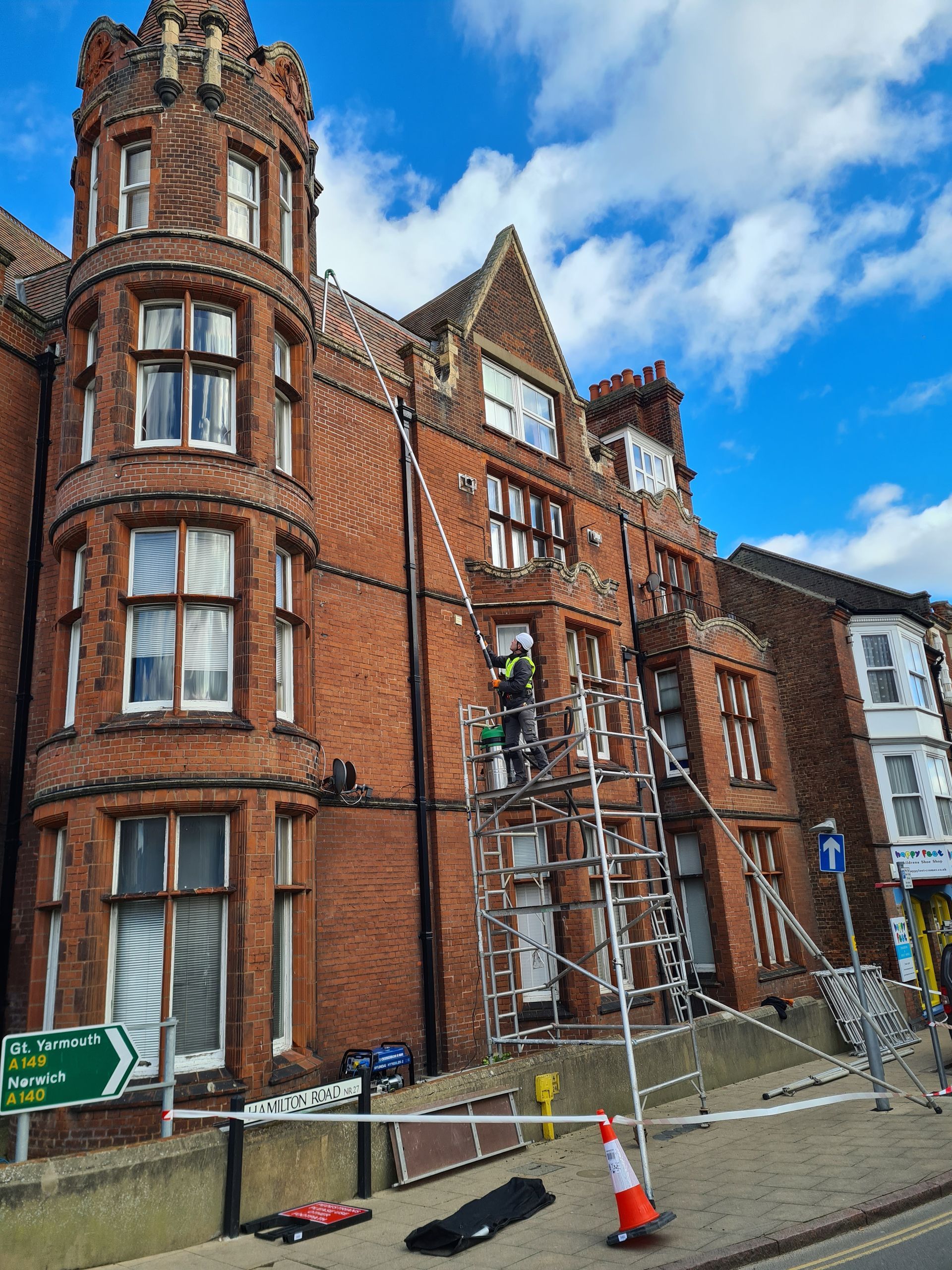 Gutter cleaning in Great Yarmouth with a vacuum and scaffold tower