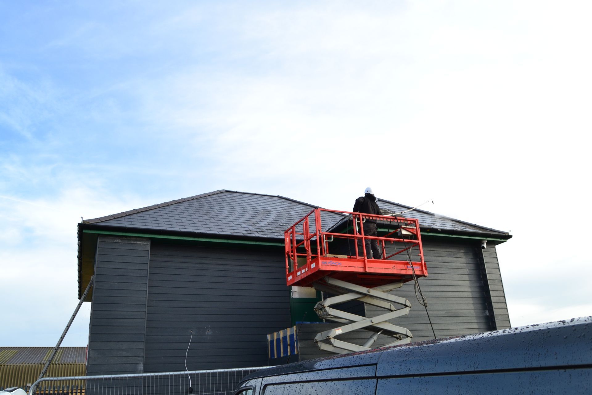 Commercial roof cleaning using a lift for safe access
