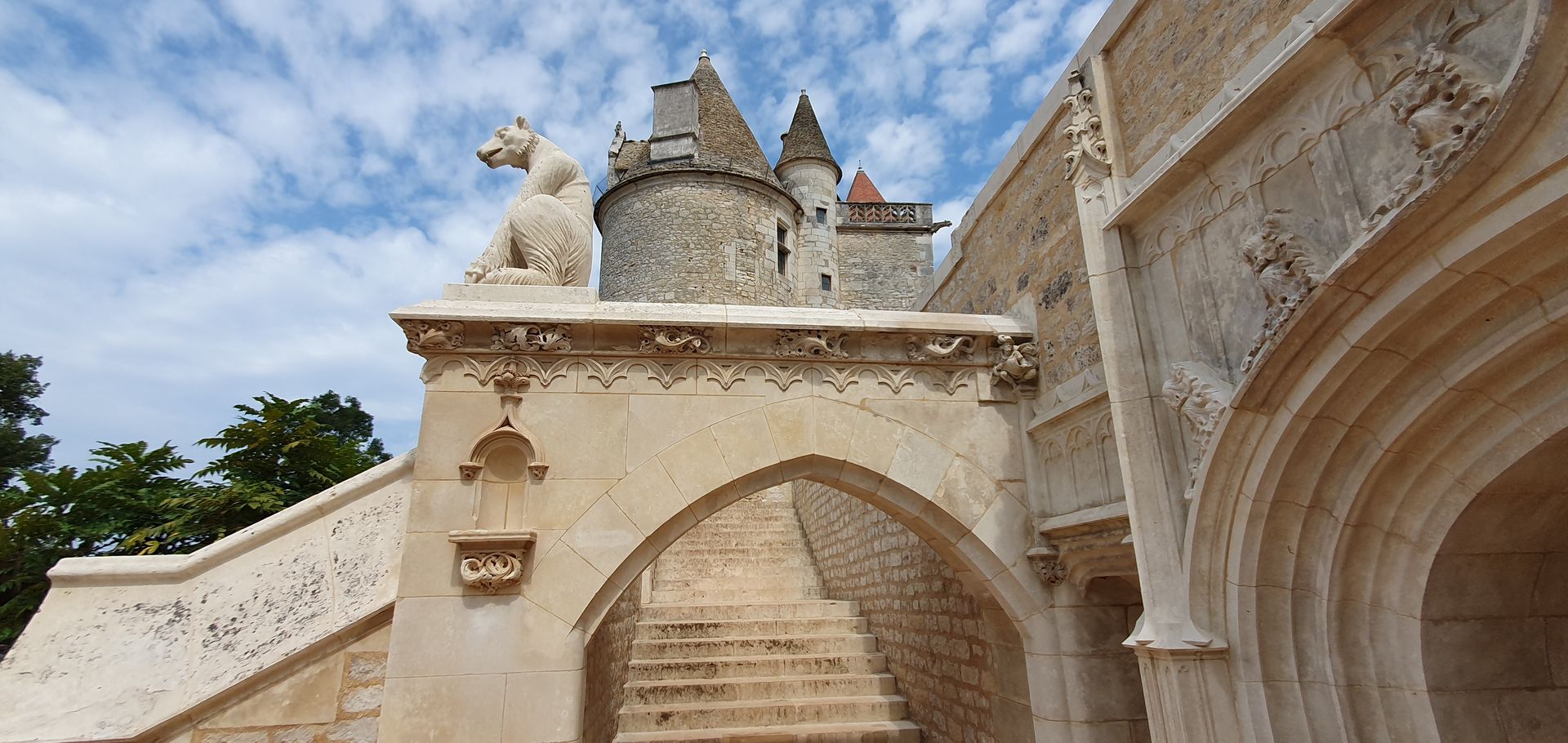 A stone building with stairs and a statue of a horse on top