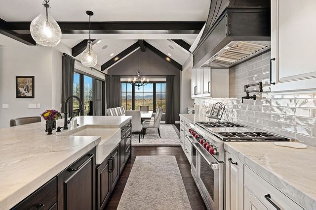 A kitchen with a stove , sink , and dishwasher.