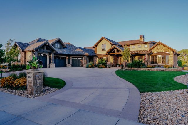 A large house with a concrete driveway leading to it